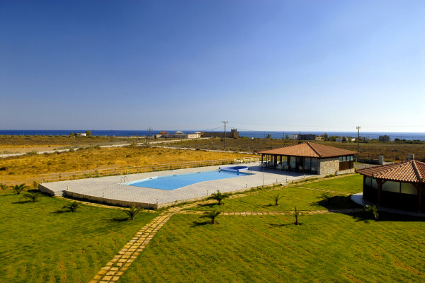 View across the pool and lawn to the sea