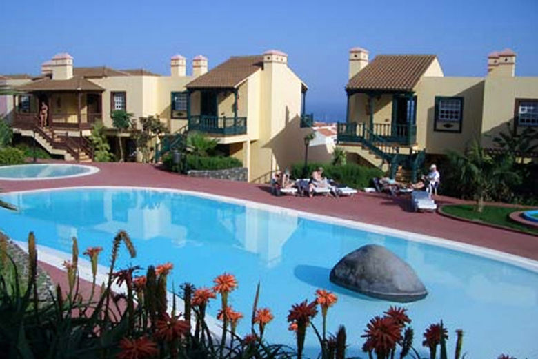 The apartments surround a free-form swimming pool