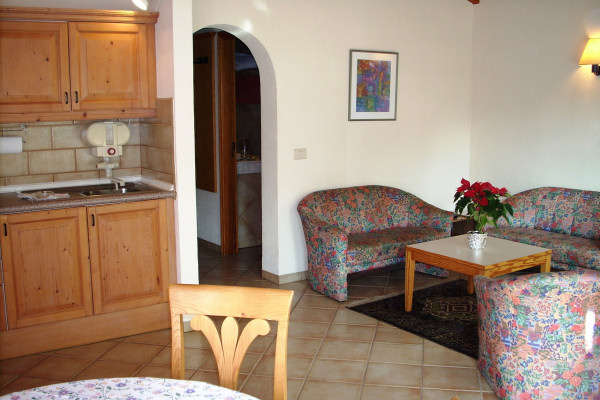 Typical living room with open-plan kitchen