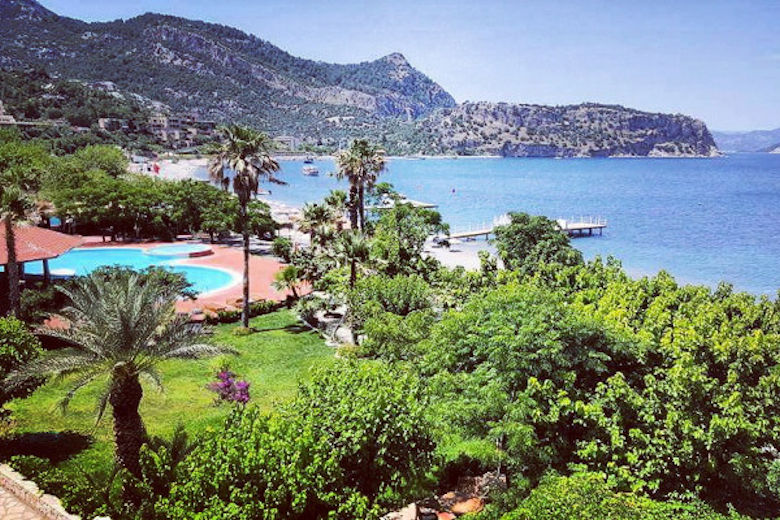 View across the hotel's garden and pool to the bay