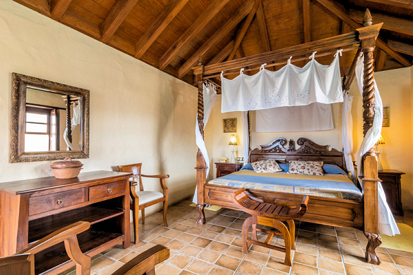 Some of the guestrooms have four-poster beds