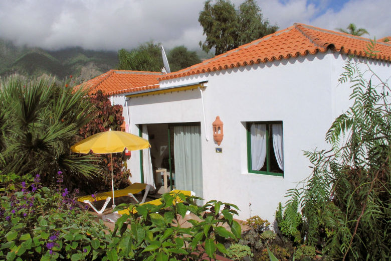 The bungalows stand amidst mature vegetation