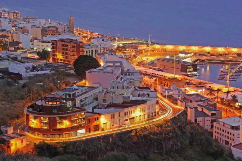 Night-time aerial view, showing the hotel in the bottom-left corner