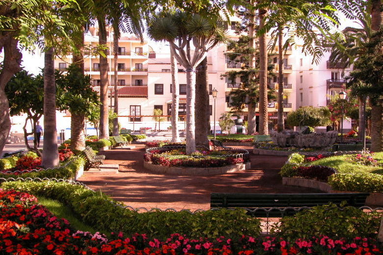 The hotel stands next to the flower-filled church square