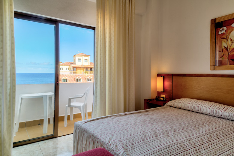 A standard room with balcony facing the sea