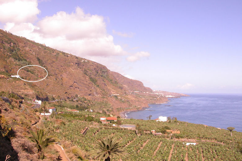 The houses (circled) nestle against a steep hillside