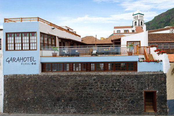 The sea-facing facade with its original defensive stone wall