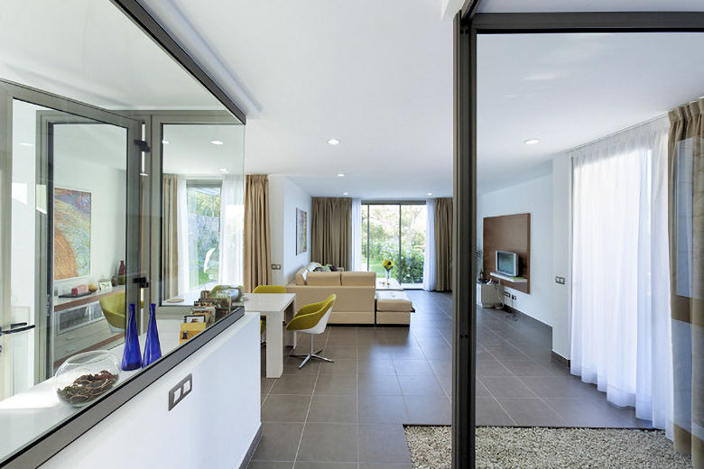 Spacious open-plan living-dining area, with kitchen on the left