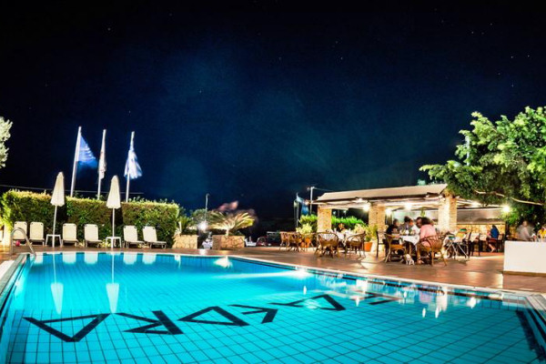 The hotel's pool and main restaurant by night