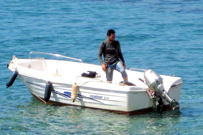 Guests are collected from nearby Loutro by Akrogiali's motorboat