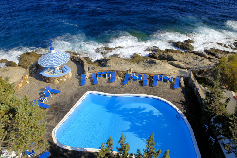 The pool terrace is built into the rocks above the shore