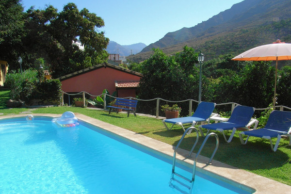 The swimming pool and one of the cottages