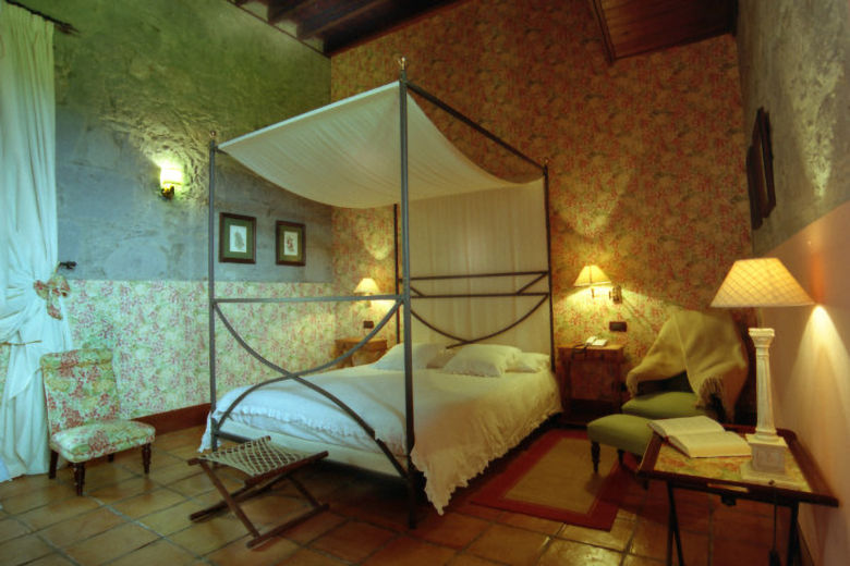 Some of the guestrooms have four-poster beds